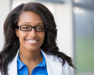 Ethnically diverse woman with glasses smiling